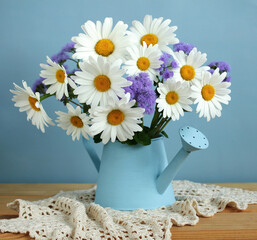 Summer bouquet of daisies and ageratum.