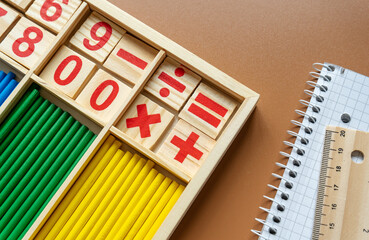 Set of supplies for mathematics and for school. Fractions, rulers, pencils, notepad on brown...