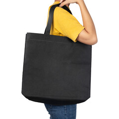 Woman holding blank black fabric canvas bag mockup.