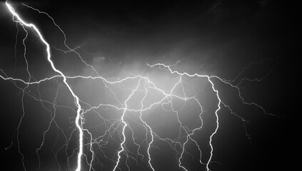 Fork lightning striking down during summer storm in black and white