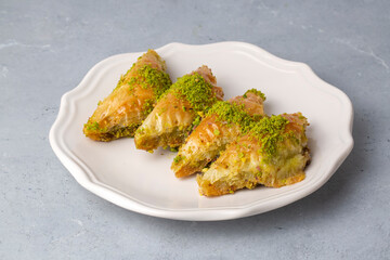 Turkish Dessert Sobiyet Baklava. Turkish pistachio baklava on a white background. Local name şöbiyet baklava