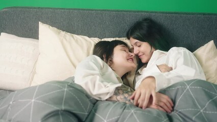 Concept of LGBT equality freedom friendship in the bedroom lesbian couple very in love kissing each other and touching with love