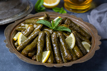 Delicious dolma (sarma) stuffed grape leaves rice, white yogurt sauce. Lebanese dolma sarma on...