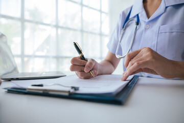 Close-up hands of doctor treatments and consults on patient in medical office.
