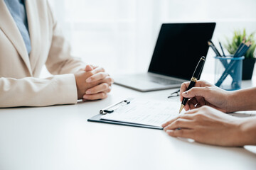 Close up of business person hands Employer interviewing job applicants, talking about resume and experience.