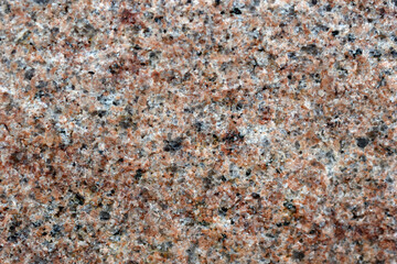 Beautiful background of gray-red granite. Granite stone close-up.