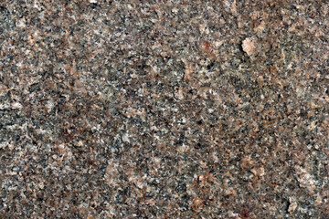 Beautiful background of gray-red granite. Granite stone close-up.