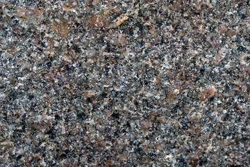 Beautiful background of gray-red granite. Granite stone close-up.