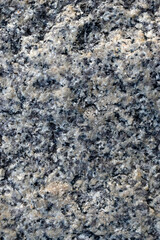 Beautiful background of gray-red granite. Granite stone close-up.