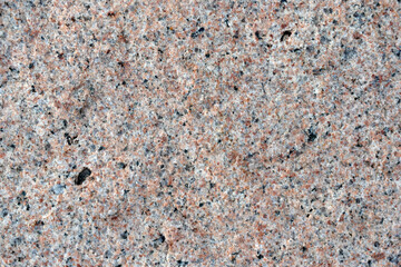 Beautiful background of gray-red granite. Granite stone close-up.
