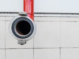 Red fire-fighting pipeline with a close-up lock