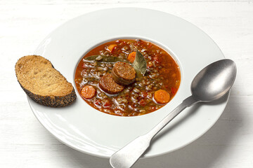 Homemade lentil stew with vegetables and chorizo