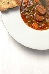 Homemade lentil stew with vegetables and chorizo