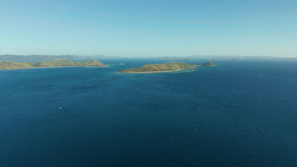 aerial view small island group in province of Palawan. Busuanga, Philippines. Seascape, islands covered with forest, sea with blue water. tropical landscape, travel concept