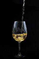 White wine falling into the glass.