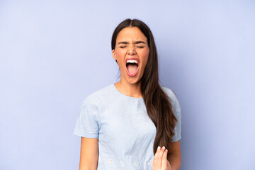 hispanic pretty woman feeling terrified and shocked, with mouth wide open in surprise