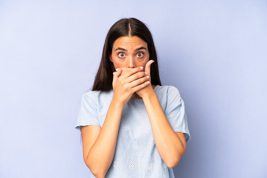 hispanic pretty woman covering mouth with hands with a shocked, surprised expression, keeping a secret or saying oops