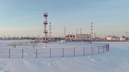 A drone flies over an emergency gas release tower at an oil and gas extraction and treatment...