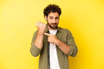 young bearded man looking impatient and angry, pointing at watch, asking for punctuality, wants to...