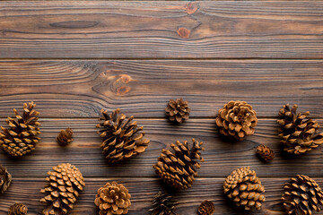 Christmas pine cones on colored paper border composition. Christmas, New Year, winter concept. Flat lay, top view, copy space