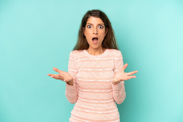 young adult pretty woman feeling extremely shocked and surprised, anxious and panicking, with a...