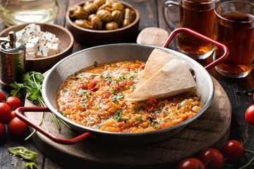 Menemen, Turkish breakfast, eggs with peppers and tomatoes, selective focus