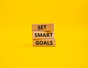Set smart goals symbol. Concept words Set smart goals on wooden blocks. Beautiful yellow background. Business and Set smart goals concept. Copy space.