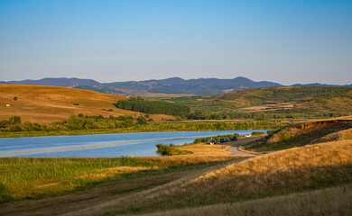 Fototapeta na wymiar Scenic view of a fishing lake in the foothills of the Apuseni Mountains or western Carpathians between the cities of Turda and Cluj Napoca, Romania