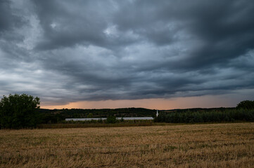 Fototapeta premium Dramatic cloudy skies as a twilight thunderstorm sweeps over the Romanian countryside