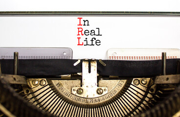 IRL in real life symbol. Concept words IRL in real life typed on the old retro typewriter on a beautiful white background. Business and IRL in real life concept. Copy space.