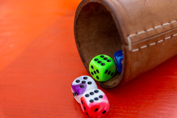 a dice cup game with colorful dice
