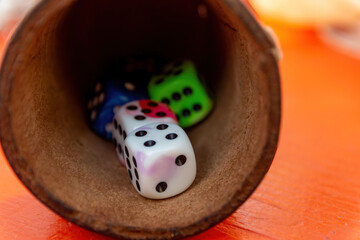a dice cup game with colorful dice