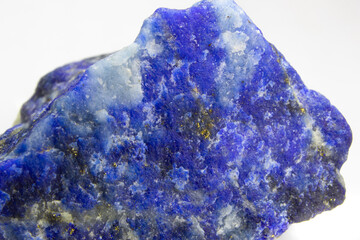 Raw Lapis lazuli rock on white background. Unpolished chunk of lapis lazuli sitting on white...