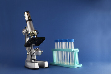 set of chemical utensils - microscope and test tubes isolated on blue background