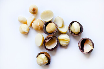 Whole nut and Macadamia kernel on a white background. Delicious whole nuts.