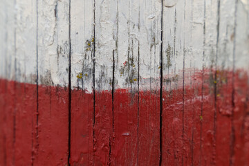 Poland flag on an old painted wooden surface.