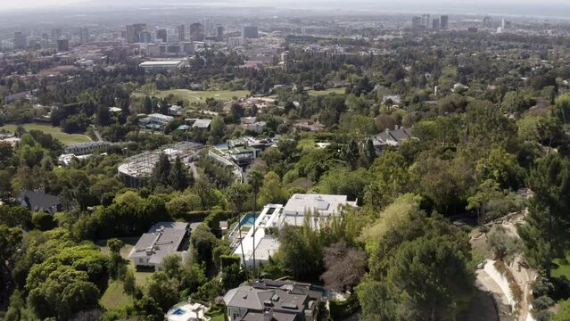 Aerial Shot Of Bel Air Mansion Amidst Trees On Hill, Drone Flying Forward During Sunny Day -  Los Angeles, California
