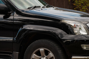 Obraz na płótnie Canvas Side view of the front of the SUV. Elegant black car