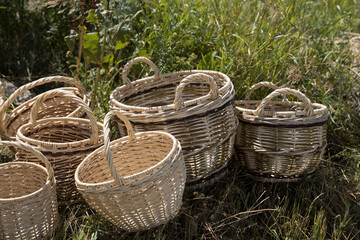 Fototapeta na wymiar baskets woven by hand lie on the grass.