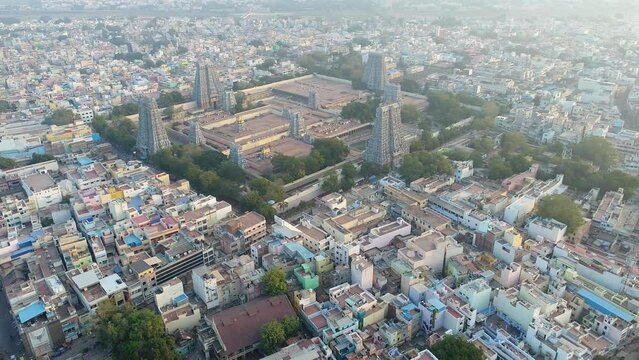 Aerial shot of huge Hindu temple in the middle of Madurai city buildings