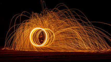 Night photography of light painting on the beach with the milky way in the background.