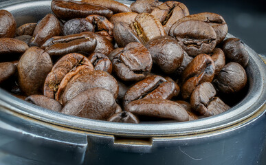 Detailed macro shot of coffee beans in portafilter.