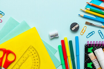 Stationery for studying at school lies on blue. Back to school. Books and textbook, apple material...