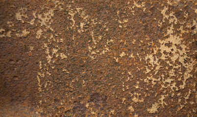 The texture of rusty iron on the wall.The background is made of rusty brown metal. Corrosion of metal with deep cavities.
