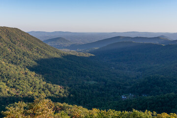 A town sits in a shaded valley in the Blue Ridge Mountains as viewed from Shenandoah National Park