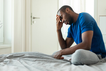 Unhappy Black Guy Thinking About Issues Having Depression In Bedroom