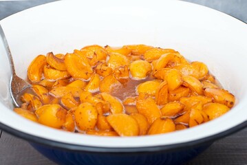 Deep plate with apricot jam. Selective focus. The concept of summer harvesting for winter.