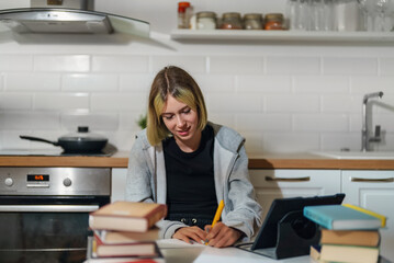 Teenage girl doing her schoolwork at home.