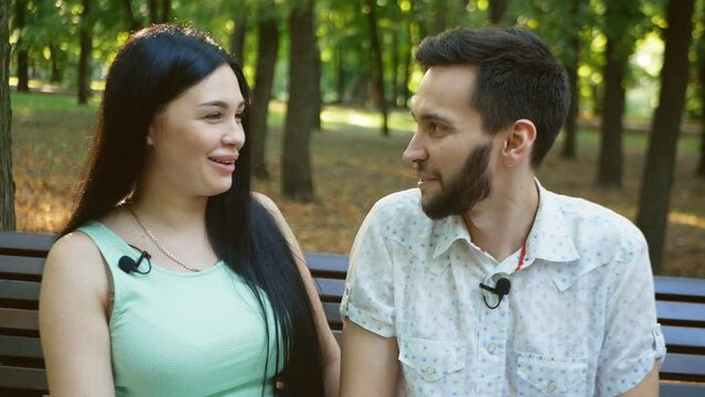 Interview with a young couple in the park for a blog. conversation funny moments in life