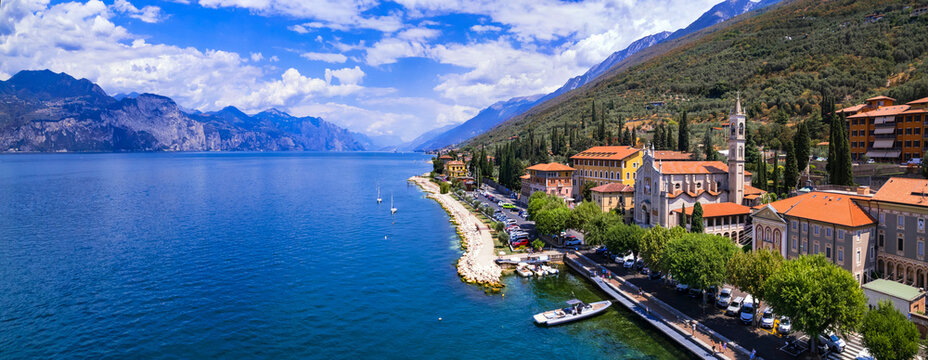 Lago di Garda Italy aerial view of Castelletto di Brenzone fishing village with colorful houses and boats lake garda travel destination scenic 4k panoramic landscape